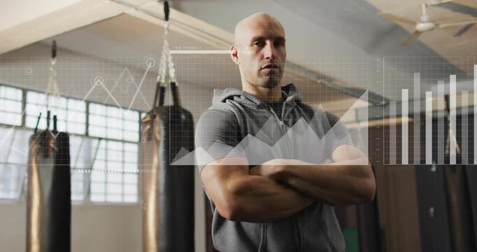 Male coach standing in boxing gym, frames progressing causing HUD, graphs, map showing training
