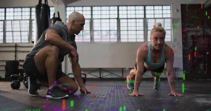 Coach cueing trainee while she performing fitness push-ups with animated charts rising over body
