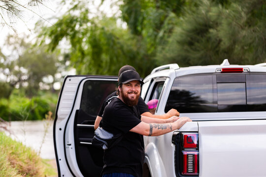 Fishermen getting ready to go home after fishing loading ute by riverside