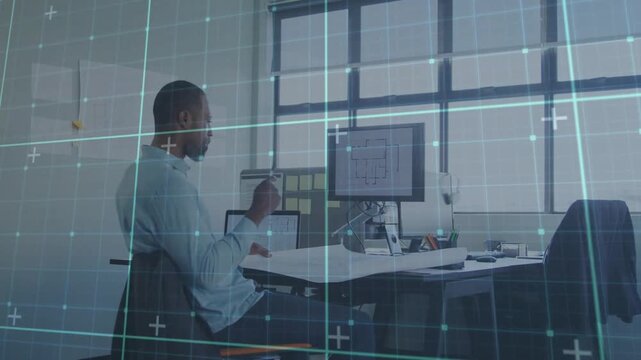 Architect adjusting plans, reaching monitor, pointing and reviewing drawings under thin blue grid