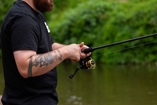 Australian man in his thirties enjoying the outdoors throwing a fishing line in the river