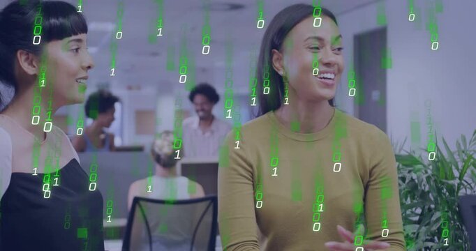 Woman in mustard top discussing tech gesturing, peer replying while green binary overlay appearing