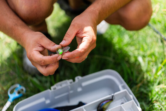 Man getting fly bait ready for fishing day in summer