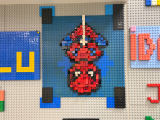 Naklejka premium Lego pixel art red spaceship on blue baseplate