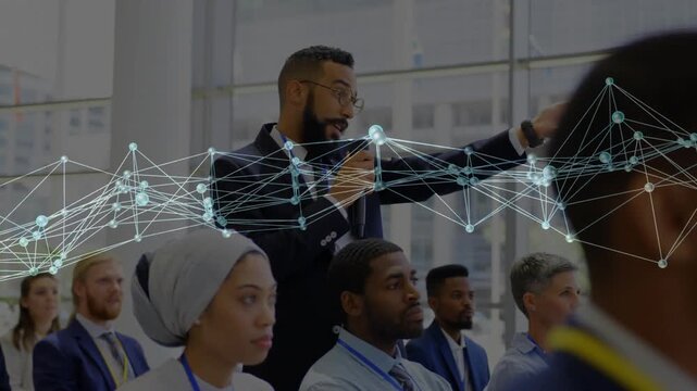 Standing man taking mic, asking question while network flowing across faces in business event