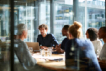 Fototapeta premium Blurred Diverse team collaborating in modern office meeting