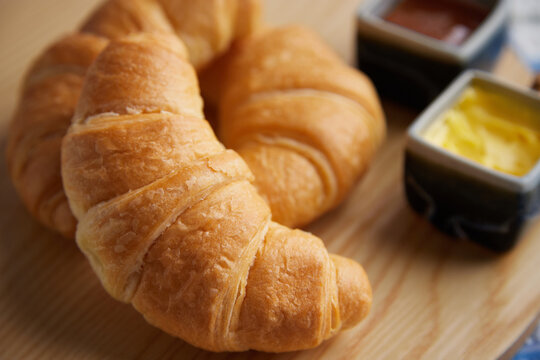 Close up of croissants with butter & jam