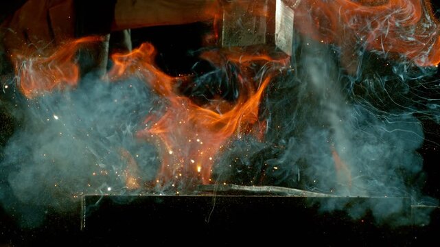 Cinematic close-up of blacksmith forging glowing hot iron on anvil with sparks flying. Shot in dramatic lighting on dark background with high-speed camera at 1000fps. Speed ramp effect.