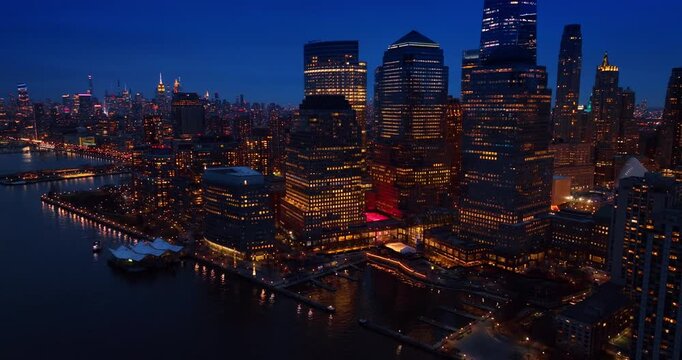 Approaching the harbor with empty berths surrounded by the gorgeous high-rises. Stunning waterfront of New York, USA at dusk time.