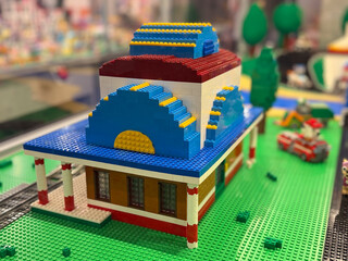 Naklejka premium Miniature lego building with blue curved roof