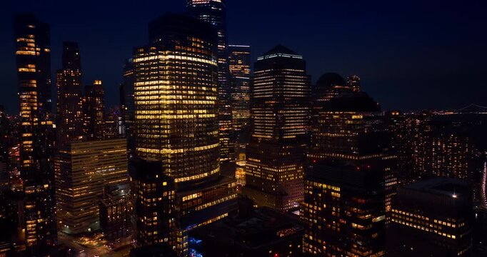 Flying up to the glass high-rises with electricity switched on. Gorgeous New York at night from drone.