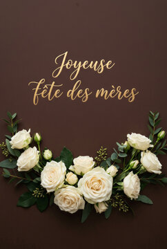 Dark brown elegant mothers day greeting card background with white rose bouquet and gold french lettering joyeuse f&ecirc;te des m&egrave;res for luxury design