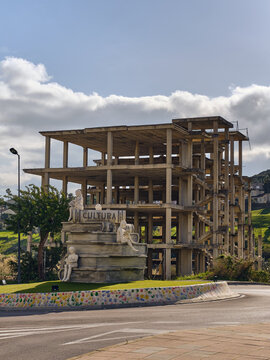 Economic Downturn And Stalled Development Unfinished Concrete Building With Cultura Sign In Manilva Spain Represents Financial Crisis And Abandoned Projects