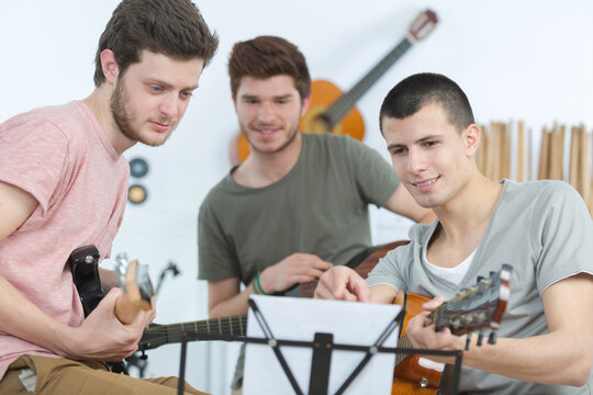 three musicians in the creative prosess of writing a song