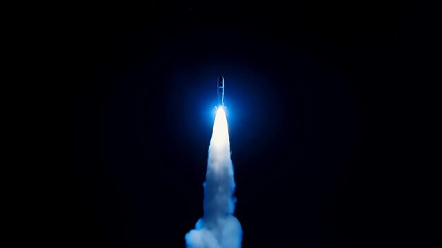 Powerful rocket launching at night with bright blue flames and dense smoke plumes