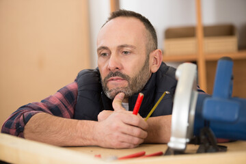 Fototapeta premium mature carpenter contemplating his crafts project