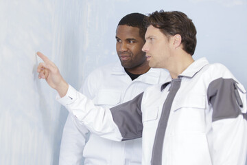 maintenance men checking an evenness of the walls © auremar