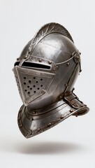 Medieval knight helmet isolated on white background. Antique metal armor with detailed engravings and worn texture, concept of chivalry, history, protection and medieval warfare.
