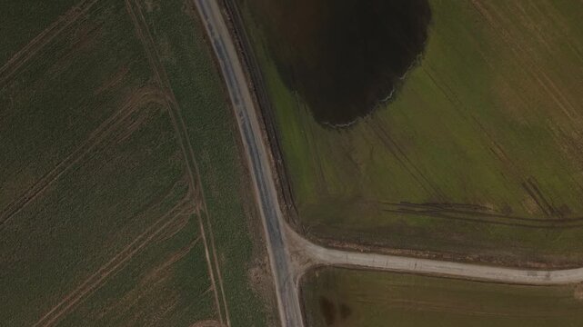 Top‑Down Forward Flight Over Farmland Road With S-Shaped Curves