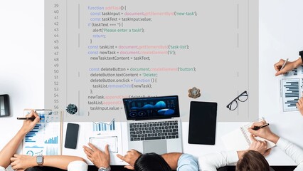 A dynamic coding workshop scene featuring a laptop displaying programming code, collaborative team...