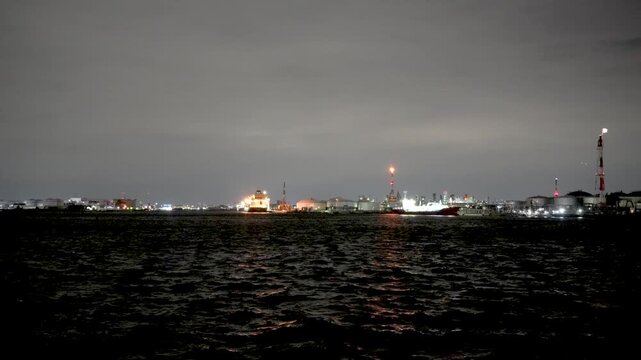 Night view of  industrial complex with glowing refineries