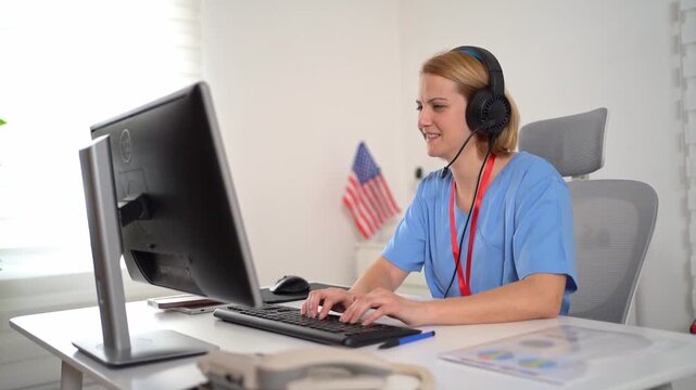 American female telemedicine operator working at a desk with headphones