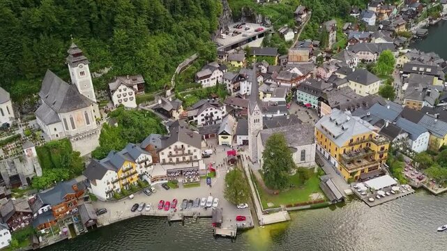 Stunning Aerial view of Hallstatt village and historic church on Lake Hallstatt, Austria. the iconic 19th-century Evangelical Church of Hallstatt and a UNESCO heritage point.