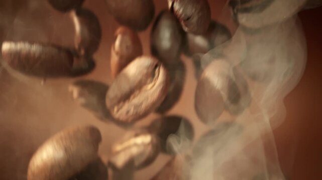 Super Slow Motion Macro of Coffee Beans Falling on Brown Cinematic Background at 1000fps.