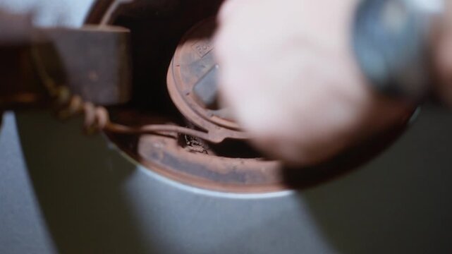 4x4 vehicle at a service station at night, close up of diesel fuel filler cap opening, clip 4