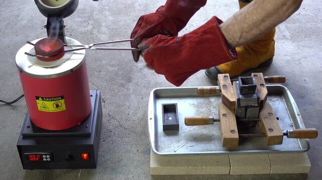 White-hot crucible removed from furnace, camera zooms in as molten metal is poured into flask mold.