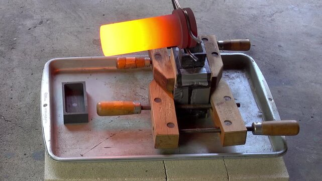 Molten metal is poured into flask mold.