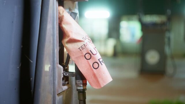4x4 vehicle arrives at a service station at night where the fuel bowser displays an &lsquo;Out of Order No Fuel Available&rsquo; sign. Clip 2