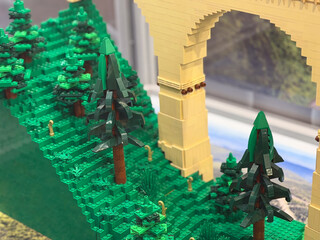 Obraz premium Lego hillside with pine trees and stone arch bridge