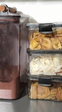 various seasonings for drinks Vertical basket of cinnamon sticks topped with dried orange slices, fragrant spice bundles arranged for market display, warm
