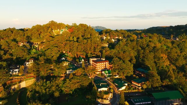 Drone pulling back over pine hills Baguio City Benguet Philippines sunrise