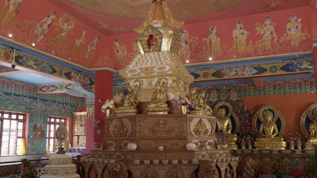 Intricate golden interior details of a Tibetan Buddhist temple in India, 4k.