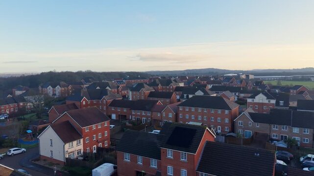 Aerial backwards drone view over a suburban housing estate in England