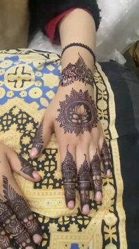 Intricate mehndi designs adorning hands and feet, showcasing traditional patterns and artistry.