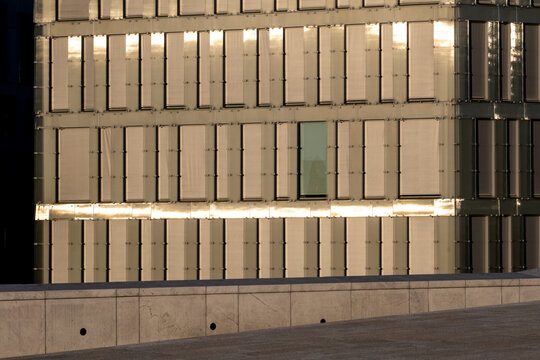 Symmetric modern building facade with panels and minimal lines showing architecture geometry pattern detail that works as a structured modern background