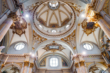 Naklejka premium Wide angle interior view of the Monte Berico Sanctuary showing the monumental columns, decorated arches, and the central dome in Vicenza, Italy 08.01.2026