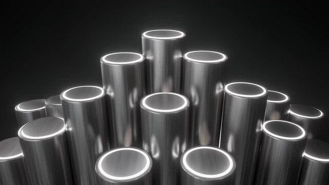 Stacked metallic cylinders arranged in a geometric formation against a dark background