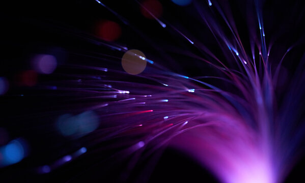 Glowing magenta optic fiber illustrating futuristic digital connection