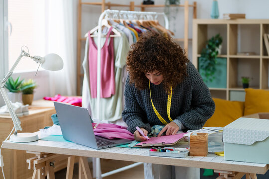 Entrepreneur preparing shipping label for online business in creative workspace