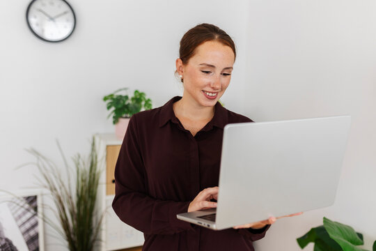 Businesswoman working online with laptop in modern office