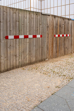 Empty urban street sidewalk with wooden fence barrier at construction edge showing wood pattern and wide space for design copy background