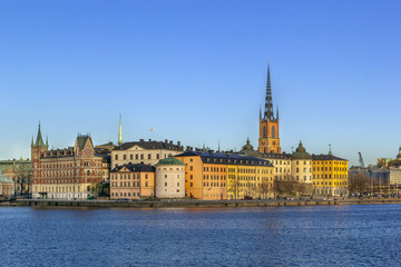 Naklejka premium Riddarholmen island architecture with the historic church spire in Stockholm, Sweden. Clear blue sky in sunny spring April day