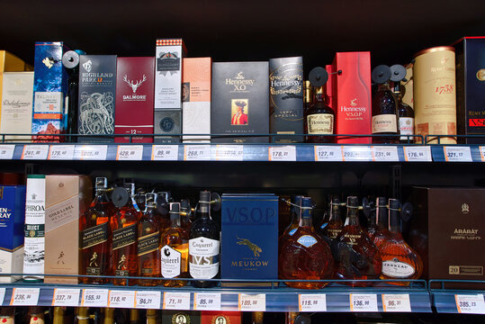 Minsk, Belarus. Mar 7, 2025. Selection of premium single malt scotch whiskey and cognac bottles on retail store shelf, brands like Hennessy and Dalmore. Alcoholic beverages displayed on shelves