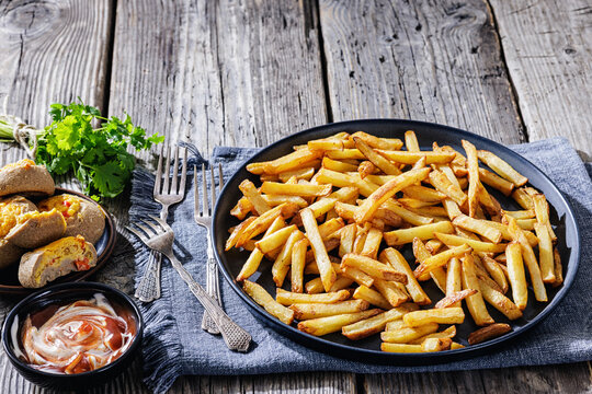 crispy french fries on a plate with dipping sauce