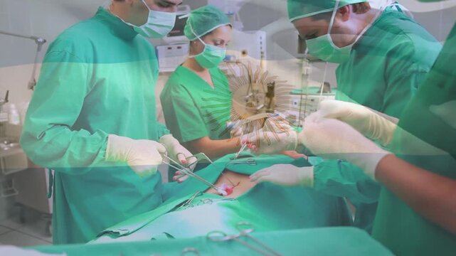 The scene is set in an operating theatre, with surgeons around an operating table