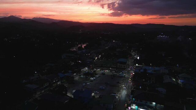 Drone aerial sunset night landscape showing town lights scattered across Cavite province near Ternate and Maragondon.